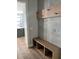 Mud room complete with bench seating, coat hooks and modern tile at 3109 W Knights Ave, Tampa, FL 33611