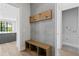 Mudroom entry featuring a bench and coat rack, next to the Kitchen and Laundry room at 3109 W Knights Ave, Tampa, FL 33611