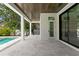 Covered patio with tile floors overlooking a pool and lush backyard at 3109 W Knights Ave, Tampa, FL 33611