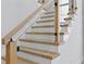 Modern staircase with glass railings and wood steps offers a bright and airy feel at 3109 W Knights Ave, Tampa, FL 33611