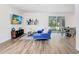 Living room features hardwood floors, sectional sofa and access to a patio at 2437 Orange Harvest Pl, Seffner, FL 33584