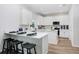 Modern kitchen with white cabinets, quartz countertops and island at 2437 Orange Harvest Pl, Seffner, FL 33584