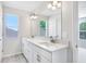Modern bathroom with double vanity and large mirror at 2437 Orange Harvest Pl, Seffner, FL 33584