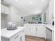 Modern kitchen with white cabinets, quartz countertops, and island at 2437 Orange Harvest Pl, Seffner, FL 33584