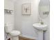 Simple bathroom with pedestal sink and wood-look floor at 2437 Orange Harvest Pl, Seffner, FL 33584