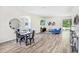 Bright dining area with hardwood floors and modern light fixture at 2437 Orange Harvest Pl, Seffner, FL 33584