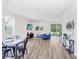 Open living room and dining area with hardwood floors and sliding glass doors leading to the backyard at 2437 Orange Harvest Pl, Seffner, FL 33584