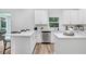 Modern kitchen with white cabinets, quartz countertops and island at 2437 Orange Harvest Pl, Seffner, FL 33584