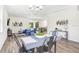 Open concept dining area with grey table, metal chairs and view of the living area at 2437 Orange Harvest Pl, Seffner, FL 33584