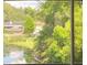 Peaceful lake view from inside the condo, showcasing natural beauty at 10423 Carrollbrook Cir # 201, Tampa, FL 33618