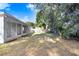 Spacious backyard with screened patio and mature trees at 2927 Minuteman Ln, Brandon, FL 33511