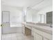 Bathroom with double vanity, soaking tub, and shower at 2927 Minuteman Ln, Brandon, FL 33511