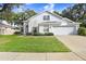 Two-story house with attached garage, manicured lawn, and mature trees at 2927 Minuteman Ln, Brandon, FL 33511