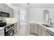Modern kitchen with stainless steel appliances and gray cabinets at 2927 Minuteman Ln, Brandon, FL 33511