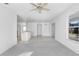Spacious living room with ceiling fan and view into kitchen at 2927 Minuteman Ln, Brandon, FL 33511