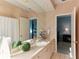 Clean bathroom with single vanity and access to bedroom at 806 Taray De Avila, Tampa, FL 33613