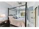 Guest bedroom with four-poster bed and built-in shelving at 806 Taray De Avila, Tampa, FL 33613