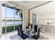 Lakefront dining room with glass table and chairs at 806 Taray De Avila, Tampa, FL 33613