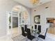 Elegant dining room featuring a glass table, black chairs, and a view into the entryway at 806 Taray De Avila, Tampa, FL 33613