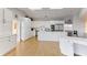 Modern white kitchen with stainless steel appliances and large island at 806 Taray De Avila, Tampa, FL 33613