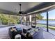 Relaxing screened patio overlooking lake with seating area and pool access at 806 Taray De Avila, Tampa, FL 33613
