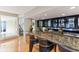 Wet bar with granite countertop and glass-front cabinets at 806 Taray De Avila, Tampa, FL 33613