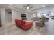 Open living room with red sofa and beige armchairs, adjacent to kitchen at 903 Heritage Groves Dr, Brandon, FL 33510