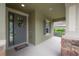 Covered front porch with gray door and stylish shutters at 903 Heritage Groves Dr, Brandon, FL 33510