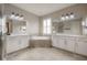 Double vanity bathroom with soaking tub and window with shutters at 903 Heritage Groves Dr, Brandon, FL 33510
