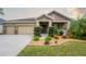 Beautiful two-story house with a three-car garage and lush landscaping at 903 Heritage Groves Dr, Brandon, FL 33510