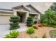 Single-Gathering house with two-car garage, lush landscaping, and stone accents at 903 Heritage Groves Dr, Brandon, FL 33510
