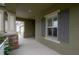 Inviting front porch with stone accents and gray shutters at 903 Heritage Groves Dr, Brandon, FL 33510