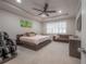 Main bedroom with king bed, massage chair, and window with plantation shutters at 903 Heritage Groves Dr, Brandon, FL 33510