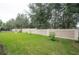 Landscaped backyard with grassy area and privacy wall at 903 Heritage Groves Dr, Brandon, FL 33510