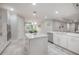 Spacious kitchen with white cabinets, granite countertops, and an island at 903 Heritage Groves Dr, Brandon, FL 33510