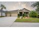 House exterior with landscaping and two-car garage at 903 Heritage Groves Dr, Brandon, FL 33510