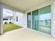 View from covered back porch toward the spacious green backyard with serene pond at 11946 Brighton Knoll Loop, Riverview, FL 33579