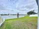 Home featuring a lush lawn and a tranquil pond with a fountain at 11946 Brighton Knoll Loop, Riverview, FL 33579