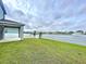 Home featuring a manicured lawn leading to a serene pond with a fountain at 11946 Brighton Knoll Loop, Riverview, FL 33579