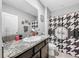 Bathroom featuring a dark vanity, granite countertop, and a black and white shower curtain at 11946 Brighton Knoll Loop, Riverview, FL 33579