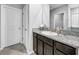 Bathroom with granite counters, dark cabinets, white sink, and tile floors at 11946 Brighton Knoll Loop, Riverview, FL 33579