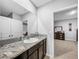 Bathroom showcasing a vanity with granite countertop, undermount sink, and neutral decor at 11946 Brighton Knoll Loop, Riverview, FL 33579