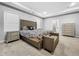 Comfortable bedroom boasts neutral color scheme, carpet flooring, and ensuite bathroom at 11946 Brighton Knoll Loop, Riverview, FL 33579