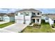 Stunning two-story home featuring a manicured lawn, a three-car garage and gorgeous water view at 11946 Brighton Knoll Loop, Riverview, FL 33579
