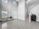 Welcoming foyer with soaring ceilings, staircase, and tiled flooring leading into the home at 11946 Brighton Knoll Loop, Riverview, FL 33579