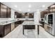 Spacious kitchen featuring dark wood cabinetry, granite countertops, and a stainless steel refrigerator at 11946 Brighton Knoll Loop, Riverview, FL 33579