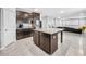 Open-concept kitchen with granite island flows into the living area for easy entertaining at 11946 Brighton Knoll Loop, Riverview, FL 33579