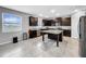 Bright kitchen boasting a center island, dark cabinets, stainless steel appliances and tile floors at 11946 Brighton Knoll Loop, Riverview, FL 33579