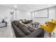 Comfortable living room with a large sectional sofa and projector screen for movie nights at 11946 Brighton Knoll Loop, Riverview, FL 33579