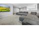 Cozy loft area featuring a gray sectional sofa, soft carpeting, and ample space at 11946 Brighton Knoll Loop, Riverview, FL 33579